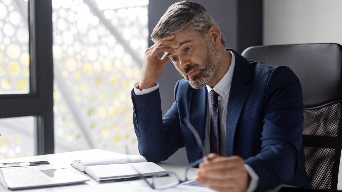 Entrepreneurship Crisis. Depressed Middle Aged Businessman Sitting At Workplace In Office, Pensive Upset Mature Entrepreneur In Suit Suffering Business Problems, Thinking About Solution, Free Space
