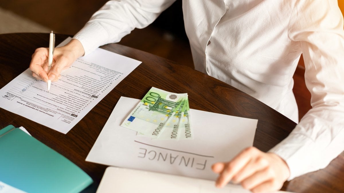 Woman working with finances on the table. Money, papers