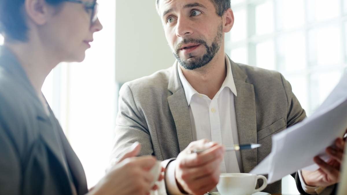 Businessman explaining document to co-worker