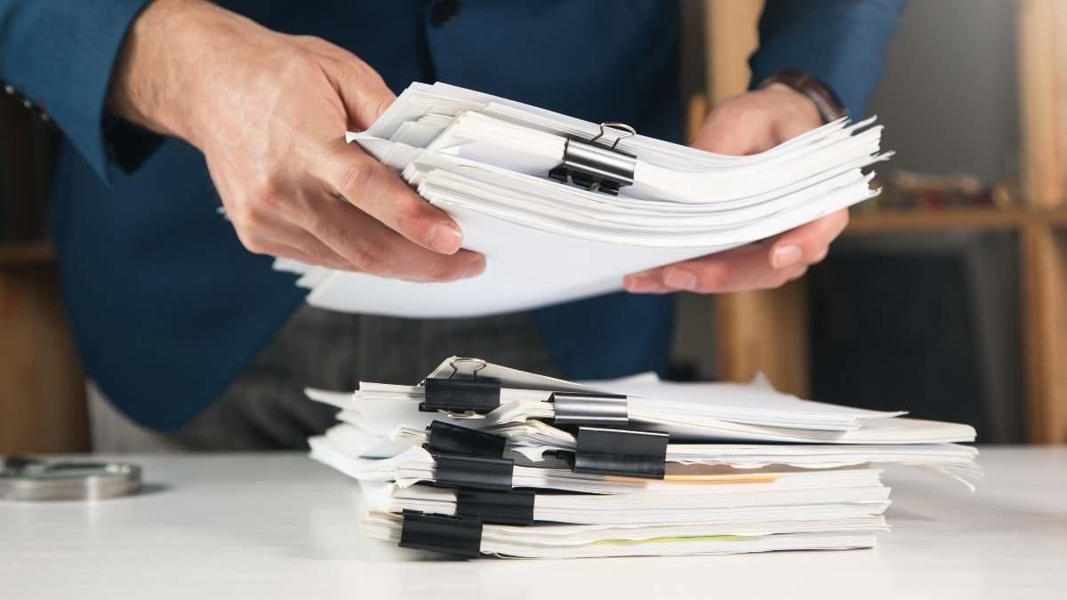 Businessman holding documents in office, closeup