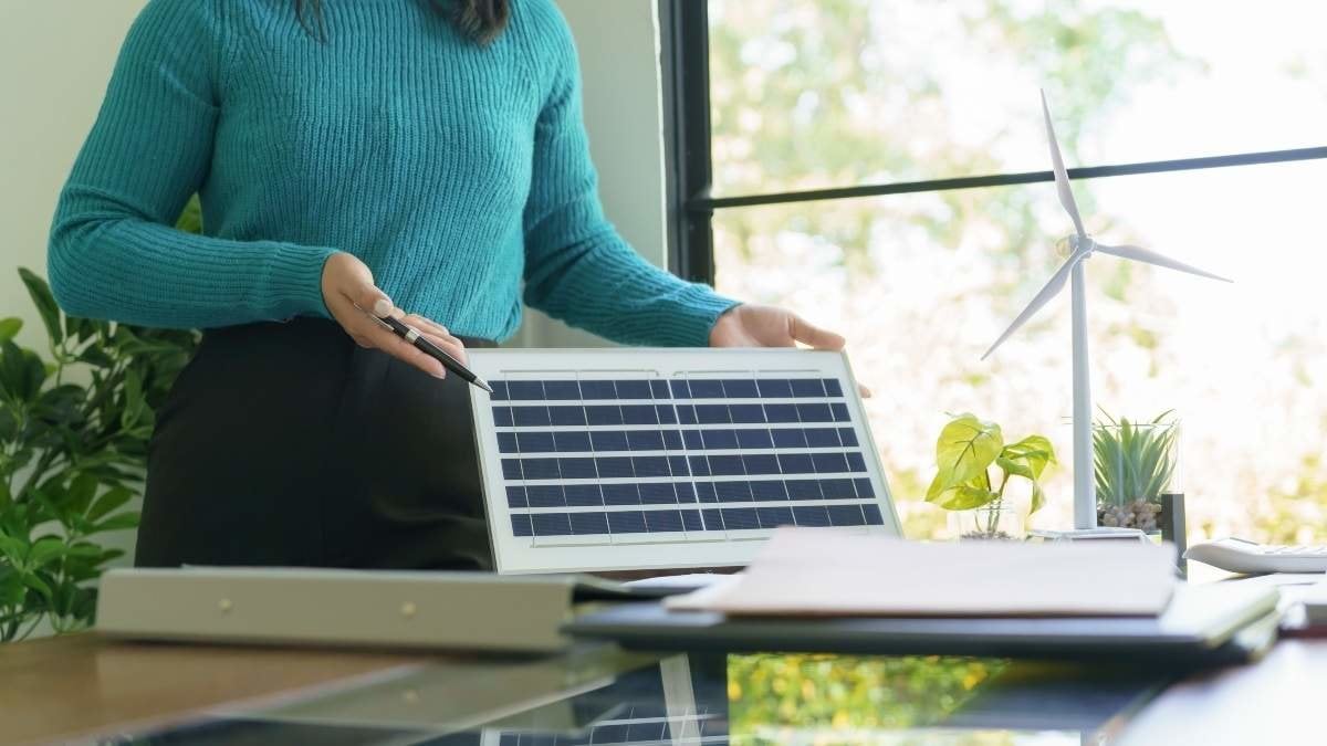 Solar panels green energy Business people working in green eco friendly office business meeting creative ideas for business eco friendly professional teaching corporate people sustainable electricity.