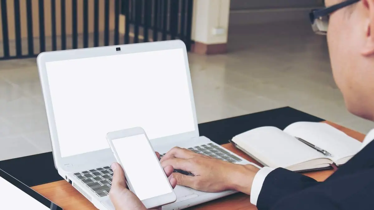 Businessman use laptop and smart phone working on business. The blank screen with copy space for your text or advertising content. Selective focus. Clipping path in picture.