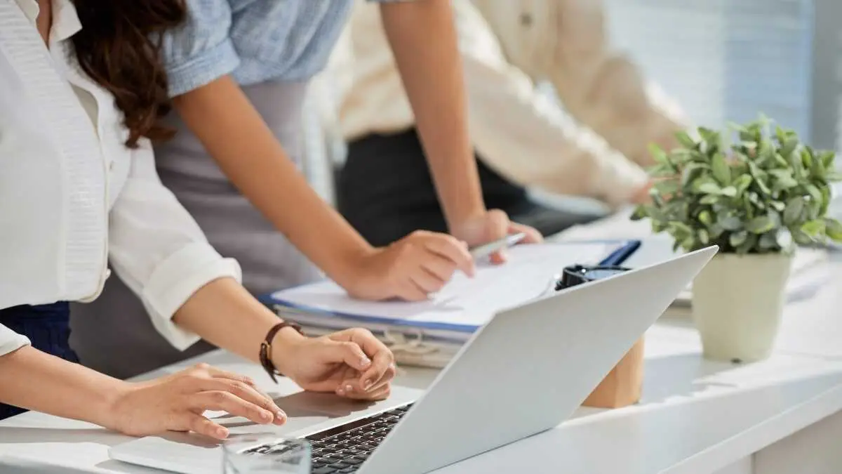 Cropped image of business ladies reading e-mails on laptop screen