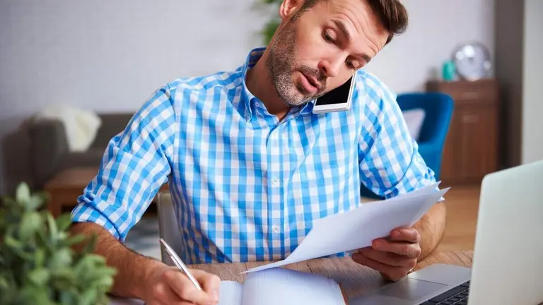 Multitasking man working at home office