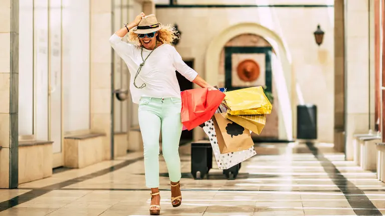 one young and beautiful woman enjoying and having fun at the mall with the black friday shopping and buying clothes and gifts of presents