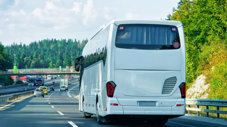 White Tourist bus in the road in Poland. Travel concept.