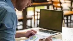 Business man viewing summary and annual report at office.Financial adviser planning budget and pointing at document and discussion on mistake work.Business man and account concept