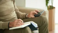 Cropped image of senior man counting his expences